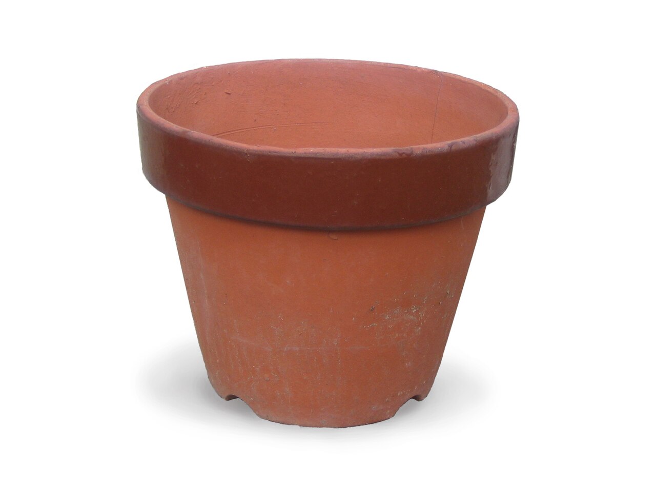 A plain terracotta pot with small notches in its base for drainage